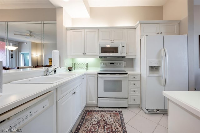 kitchen featuring white appliances, light tile patterned floors, sink, white cabinetry, and ceiling fan