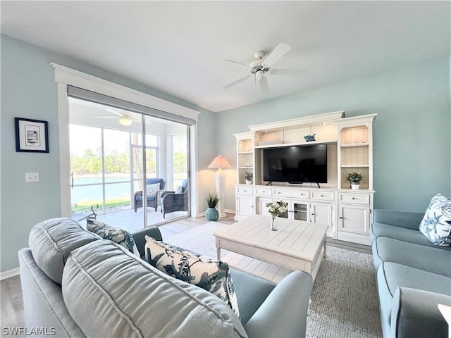 living room featuring hardwood / wood-style flooring and ceiling fan