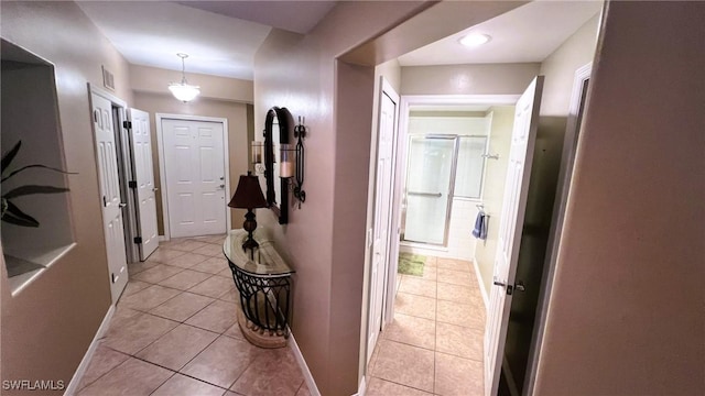 corridor with light tile patterned flooring