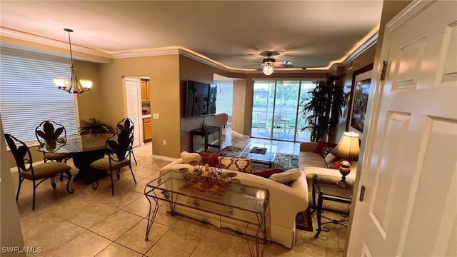 living room with crown molding, ceiling fan with notable chandelier, and light tile patterned floors