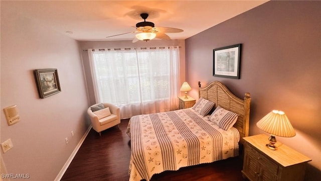 bedroom with dark hardwood / wood-style flooring and ceiling fan