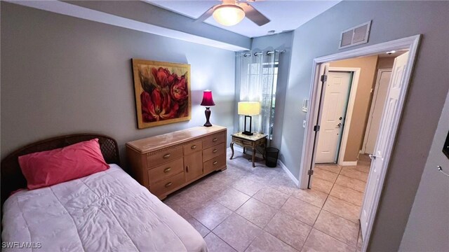 tiled bedroom featuring ceiling fan