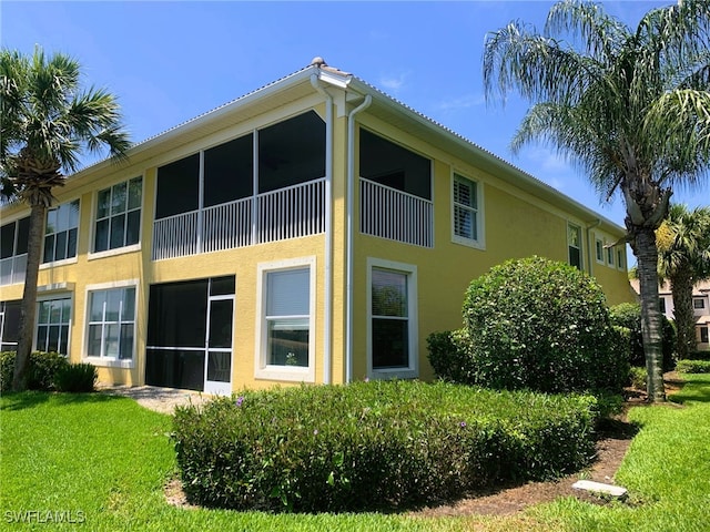 view of side of home with a yard