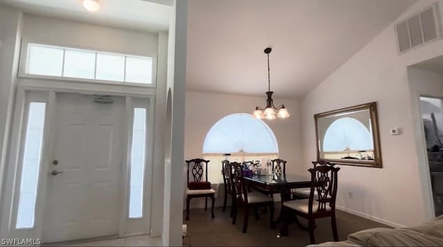 foyer entrance featuring high vaulted ceiling and a notable chandelier