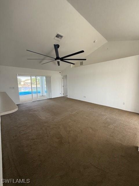 spare room with lofted ceiling, carpet flooring, and ceiling fan