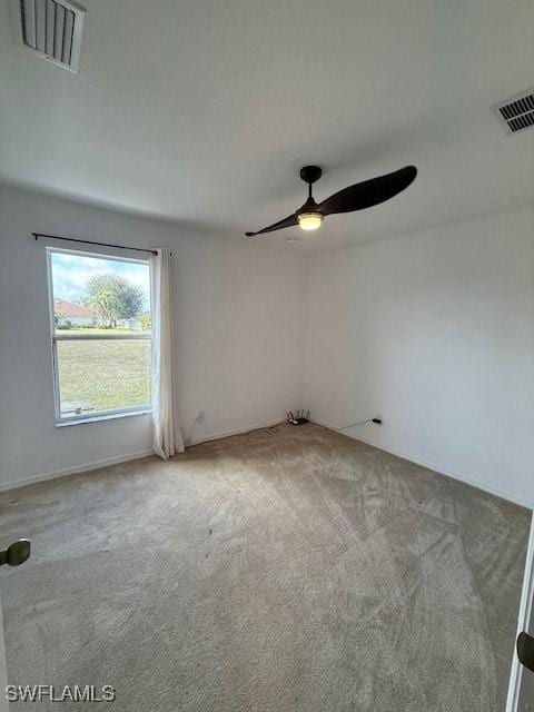 unfurnished room with ceiling fan and carpet flooring