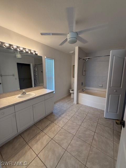 full bathroom with shower / bath combination with curtain, tile patterned flooring, vanity, ceiling fan, and toilet