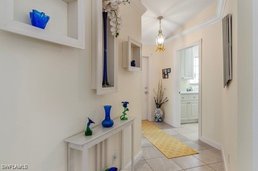 corridor with lofted ceiling, crown molding, and light tile patterned floors