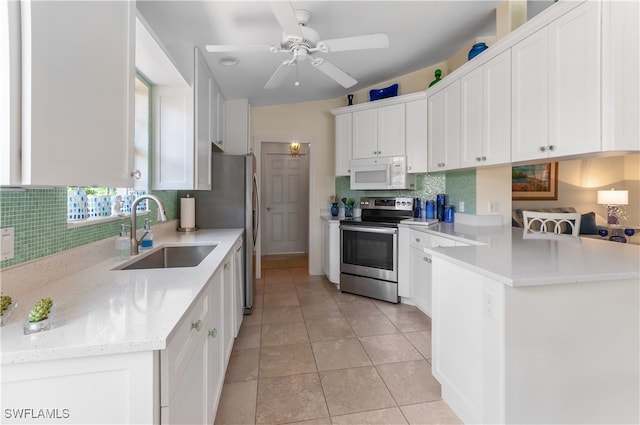 kitchen with kitchen peninsula, sink, light tile patterned flooring, stainless steel range with electric cooktop, and white cabinets