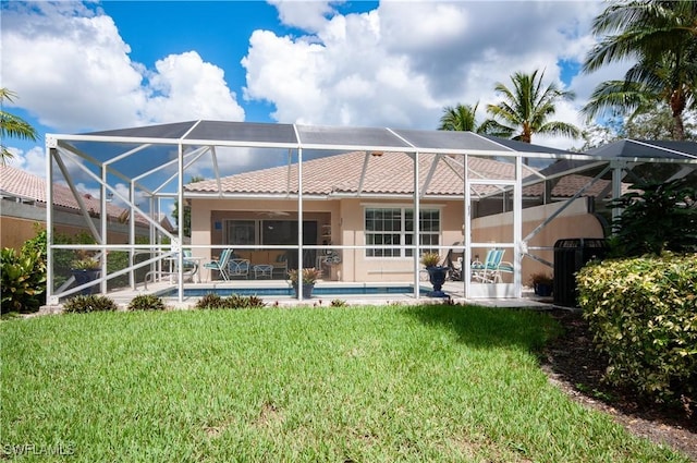 7804 Umberto Ct, Naples, FL 34114 - rear view of property featuring a tiled roof, glass enclosure, a yard, and stucco siding