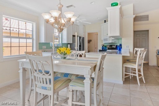 tiled dining area with ornamental molding and a chandelier