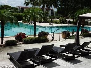 community pool with a patio area