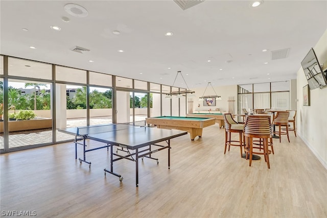 playroom featuring light wood-type flooring, a healthy amount of sunlight, and pool table