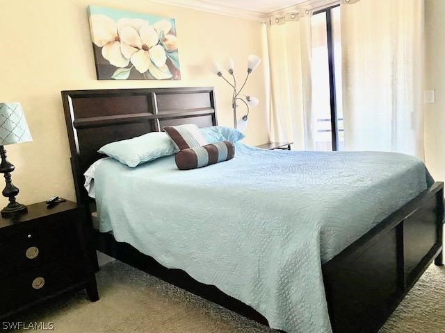 bedroom with multiple windows and ornamental molding