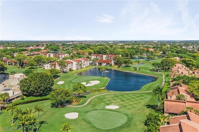 drone / aerial view featuring golf course view and a water view