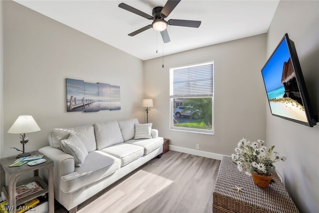 living room with ceiling fan and light wood-type flooring