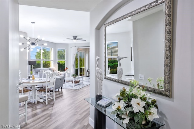 interior space with an inviting chandelier and light hardwood / wood-style flooring