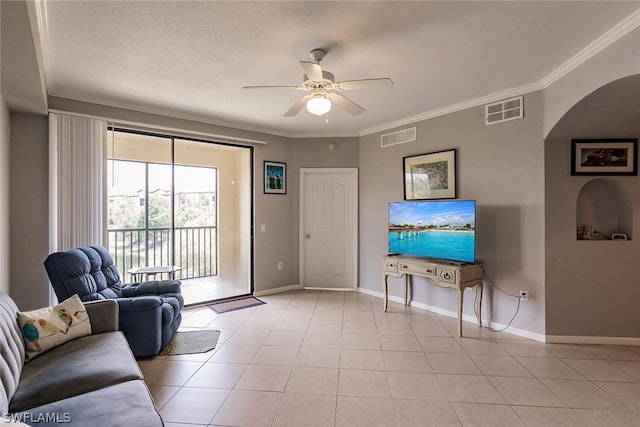 living room featuring ceiling fan, crown molding, and light tile patterned flooring