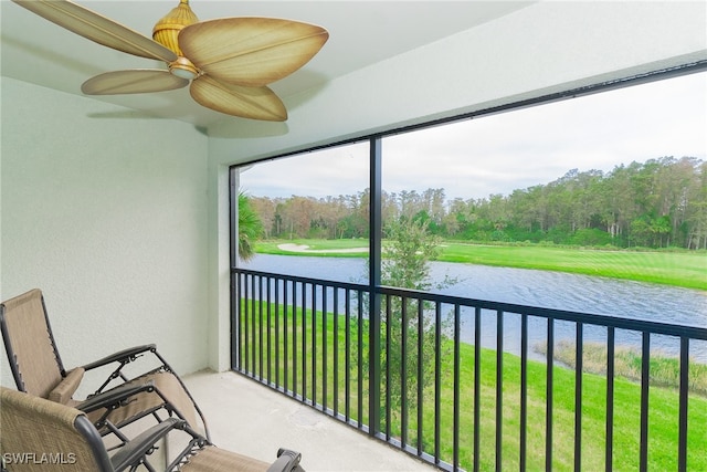 unfurnished sunroom with a water view and ceiling fan