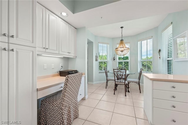 dining space with an inviting chandelier and light tile patterned floors