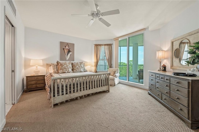 bedroom featuring light carpet, ceiling fan, and access to outside