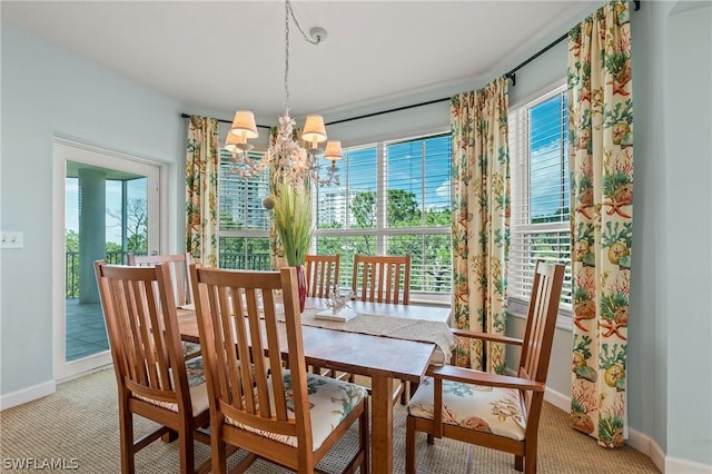 dining area featuring an inviting chandelier and light carpet