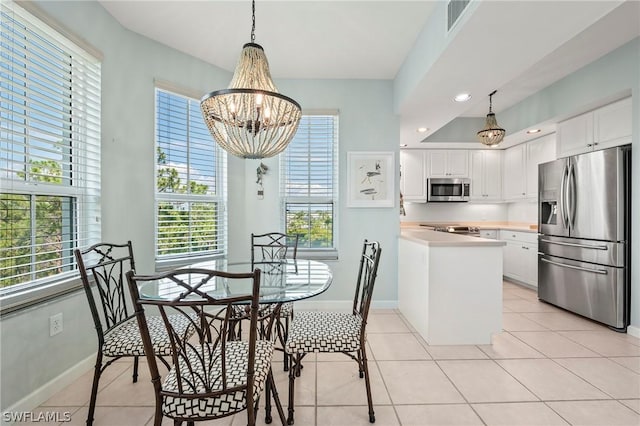 dining space with an inviting chandelier and light tile patterned floors