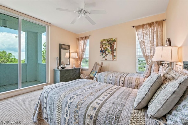 bedroom featuring ceiling fan, multiple windows, and access to exterior