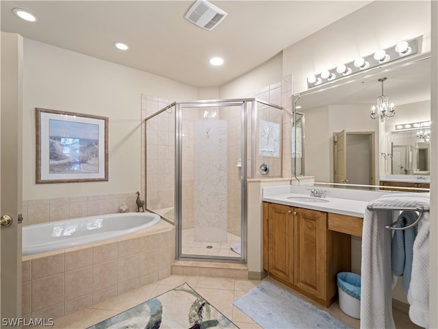 bathroom featuring tile patterned flooring, vanity, independent shower and bath, and a chandelier