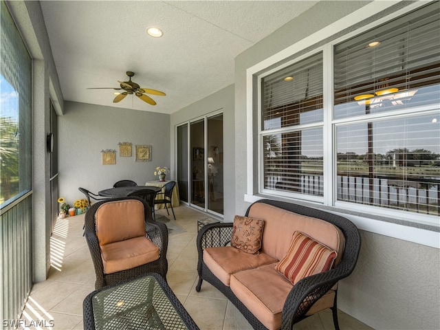 sunroom featuring ceiling fan