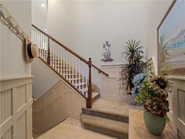 16521 Goldenrod Ln Unit 202, Alva, FL 33920 - stairs featuring a decorative wall, wainscoting, and tile patterned floors