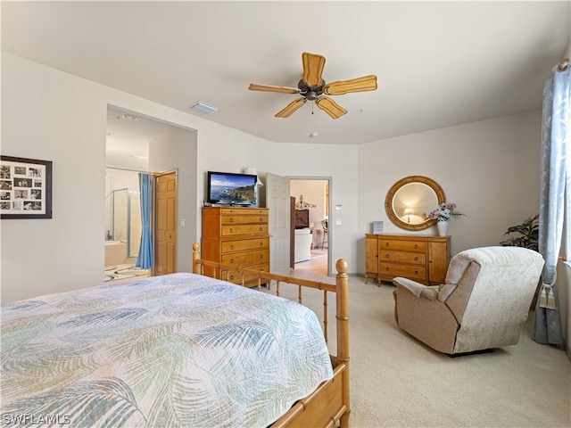 16521 Goldenrod Ln Unit 202, Alva, FL 33920 - bedroom featuring light carpet, ceiling fan, and ensuite bath
