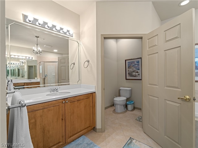 bathroom featuring vanity, a shower with door, an inviting chandelier, tile patterned floors, and toilet