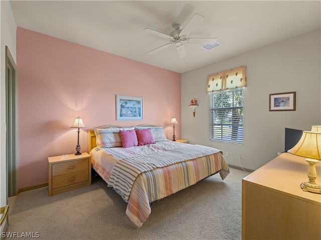 bedroom with ceiling fan and light carpet