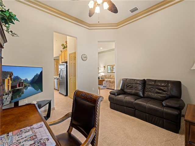 living room with light colored carpet, ceiling fan, and ornamental molding