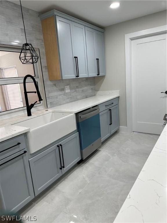 kitchen featuring gray cabinetry, a sink, and dishwashing machine