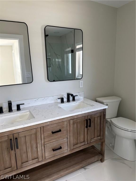 full bathroom featuring double vanity, toilet, and a sink