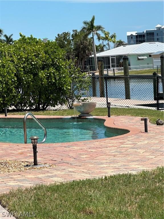 view of swimming pool featuring fence