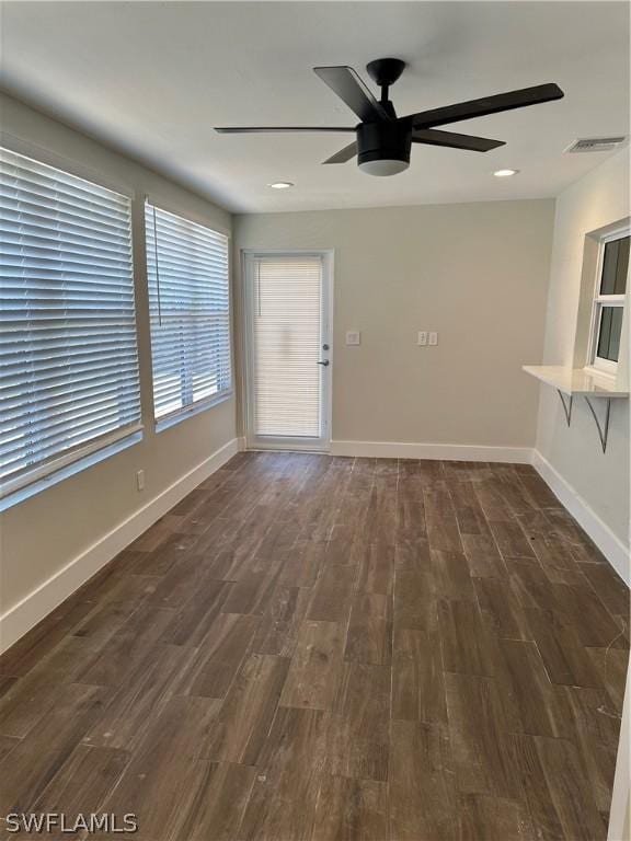 unfurnished living room with visible vents, baseboards, ceiling fan, recessed lighting, and dark wood-type flooring