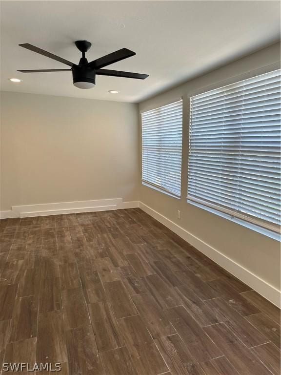 empty room featuring baseboards, recessed lighting, dark wood-type flooring, and a ceiling fan