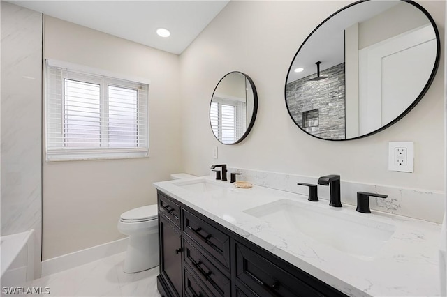 full bath with double vanity, a sink, toilet, and a shower