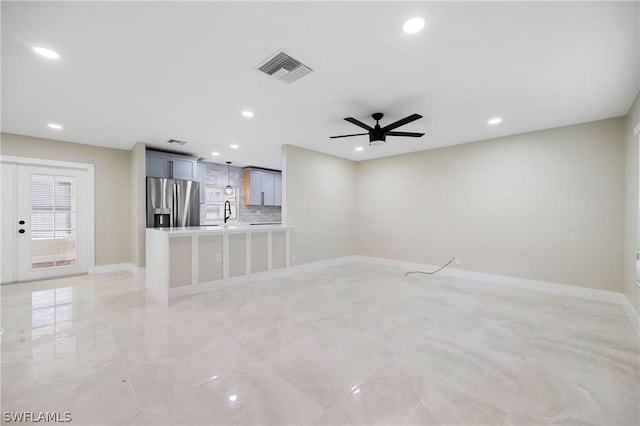 unfurnished living room with baseboards, ceiling fan, and recessed lighting