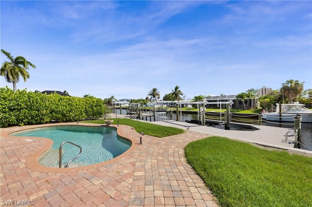 pool featuring a water view, a patio area, boat lift, and a dock