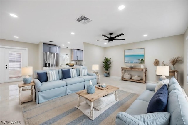 living room featuring ceiling fan, visible vents, and recessed lighting