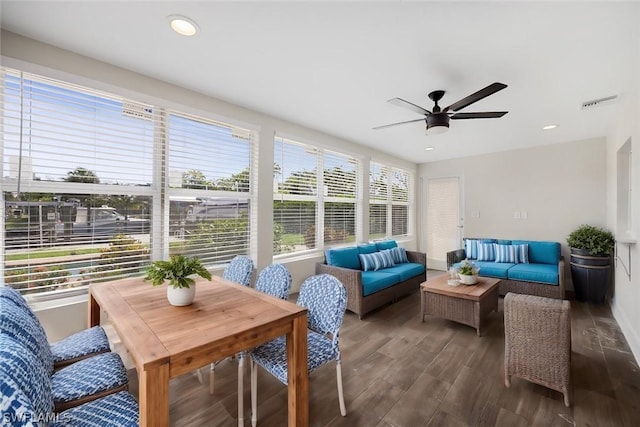 sunroom / solarium with visible vents, an outdoor hangout area, wood finished floors, and a ceiling fan