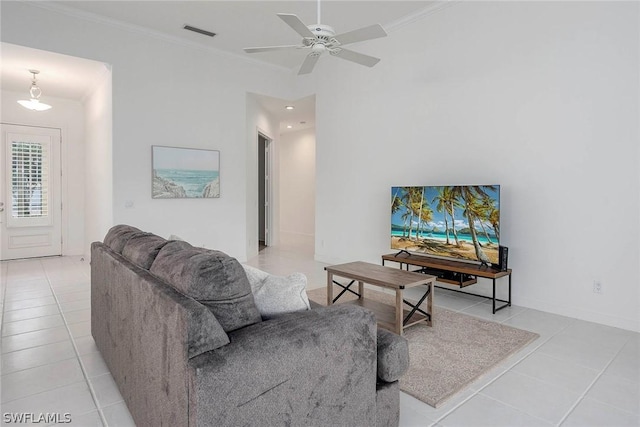 tiled living room with ceiling fan and ornamental molding