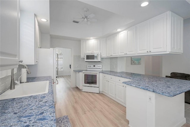 kitchen with white cabinets, white appliances, ceiling fan, and sink