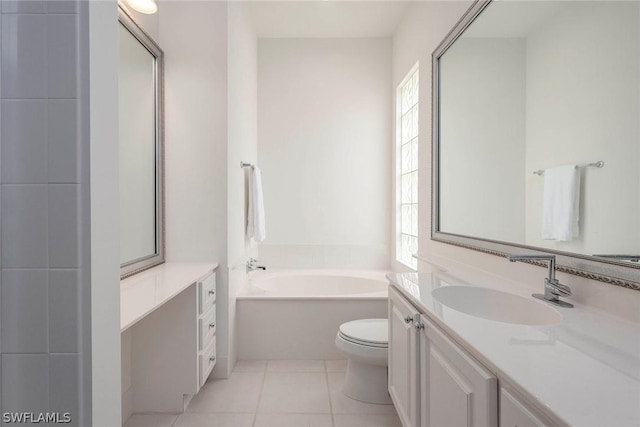 bathroom featuring tile patterned floors, vanity, toilet, and a bath