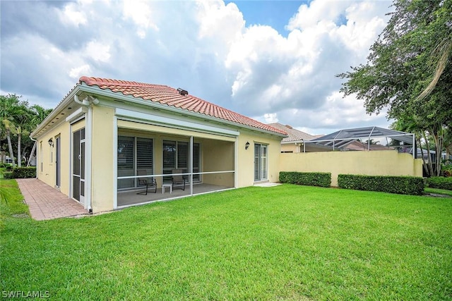 rear view of property with a yard