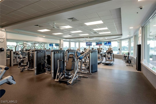 gym with a paneled ceiling